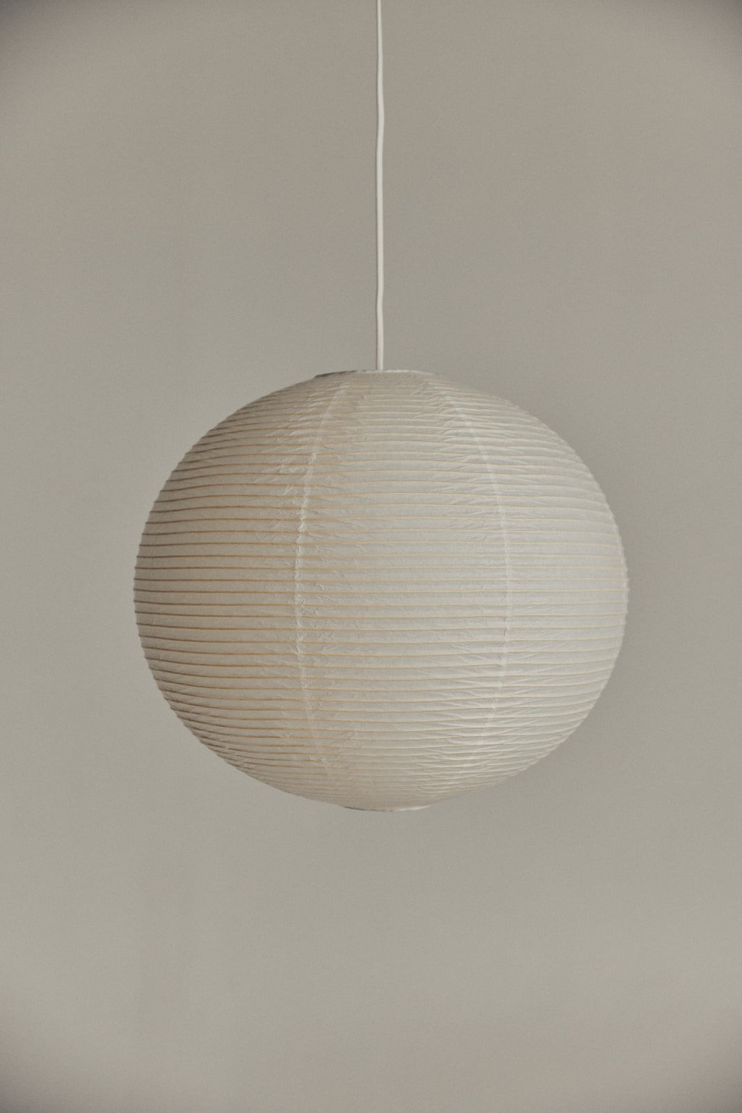 Japanese style paper lamp shade in various sizes made from highest quality cotton rice paper with natural faded color great alternatives for Isamu Noguchi Akari lamps pendant lights versatile fits in any space apartment studio retail commercial house