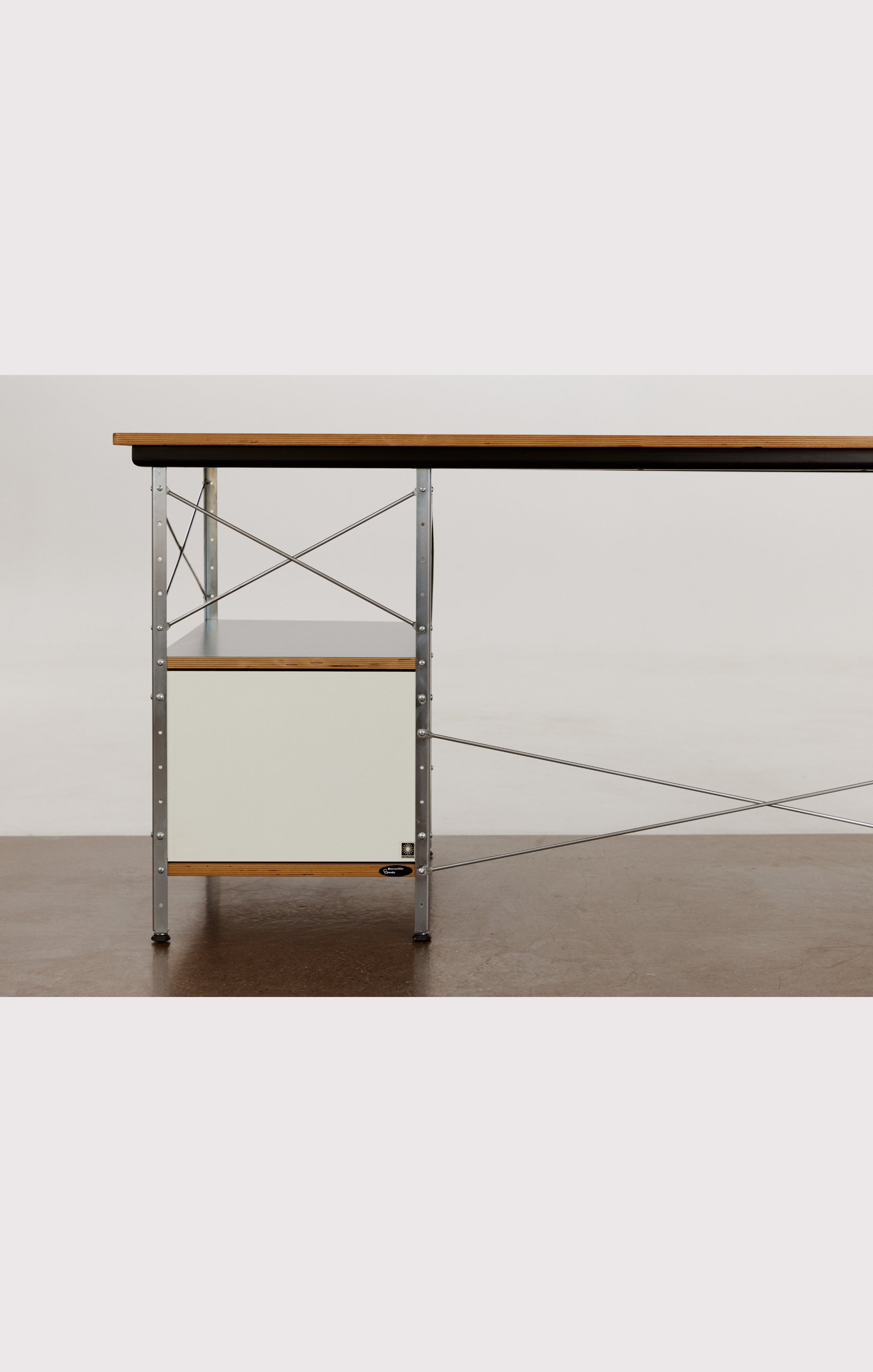 Eames desk unit with right-hand file drawer. Zinc frame with natural-colored panels. Designed by Charles and Ray Eames for Herman Miller.